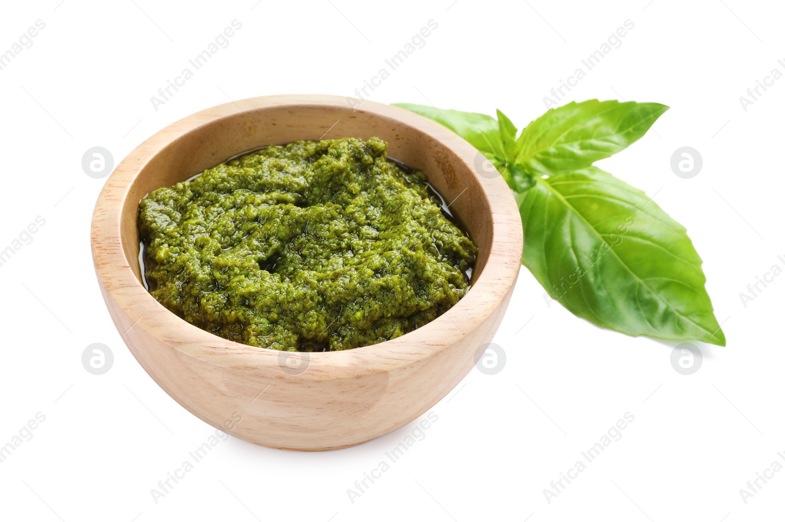 Photo of Fresh tasty pesto sauce and basil isolated on white