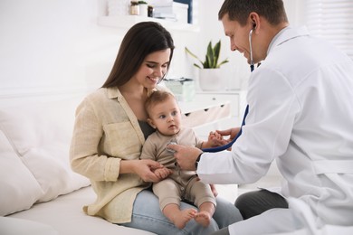 Photo of Mother with her cute baby visiting pediatrician in clinic