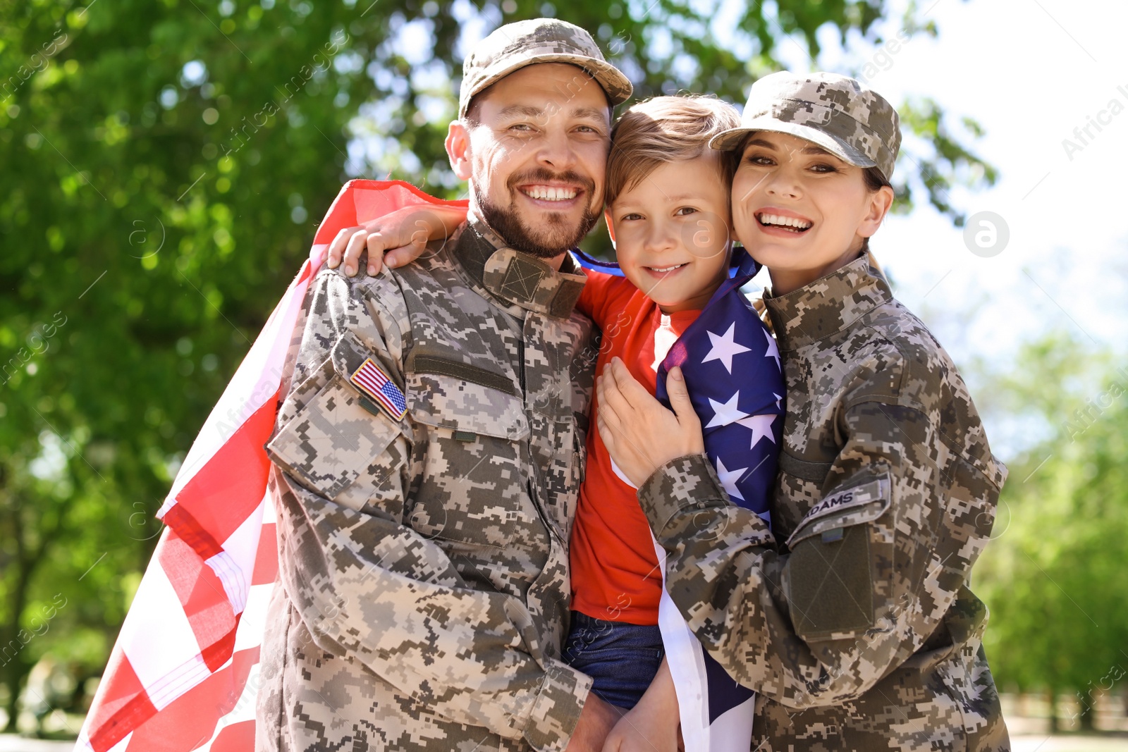 Photo of Happy military family with their son outdoors