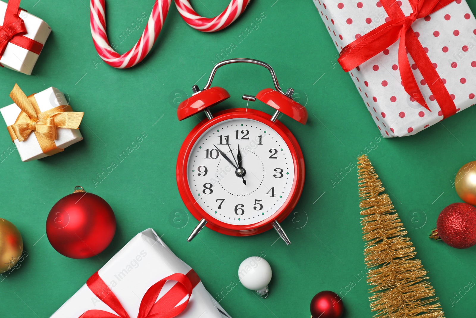 Photo of Retro alarm clock and different decor on color background, top view. Christmas countdown