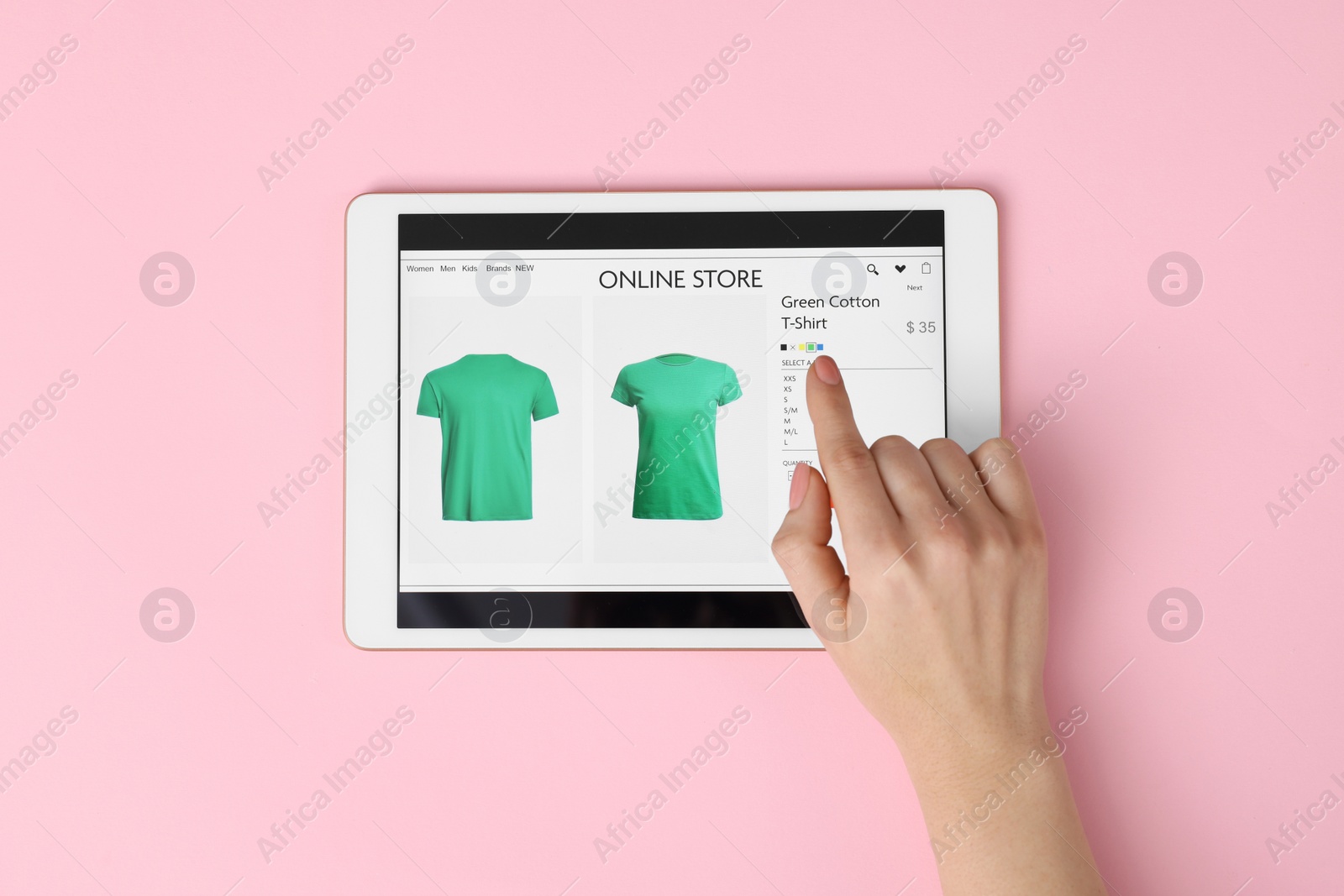 Photo of Woman with tablet shopping online on pink background, top view