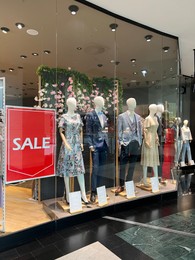 Photo of WARSAW, POLAND - JULY 13, 2022: Fashion store window display with clothes on mannequins in shopping mall