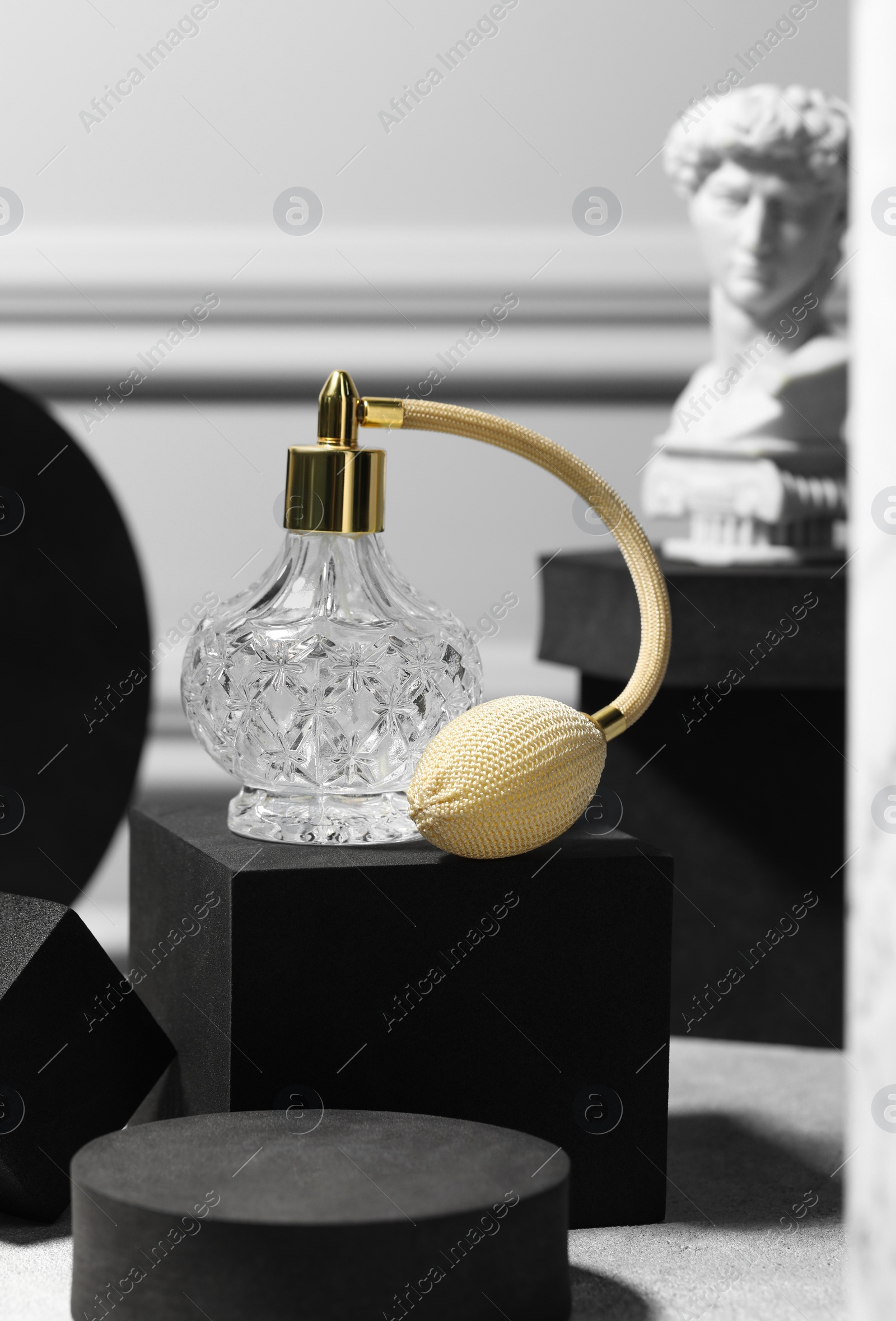 Photo of Stylish presentation of perfume bottle on light grey table