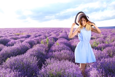 Photo of Young woman in lavender field on summer day