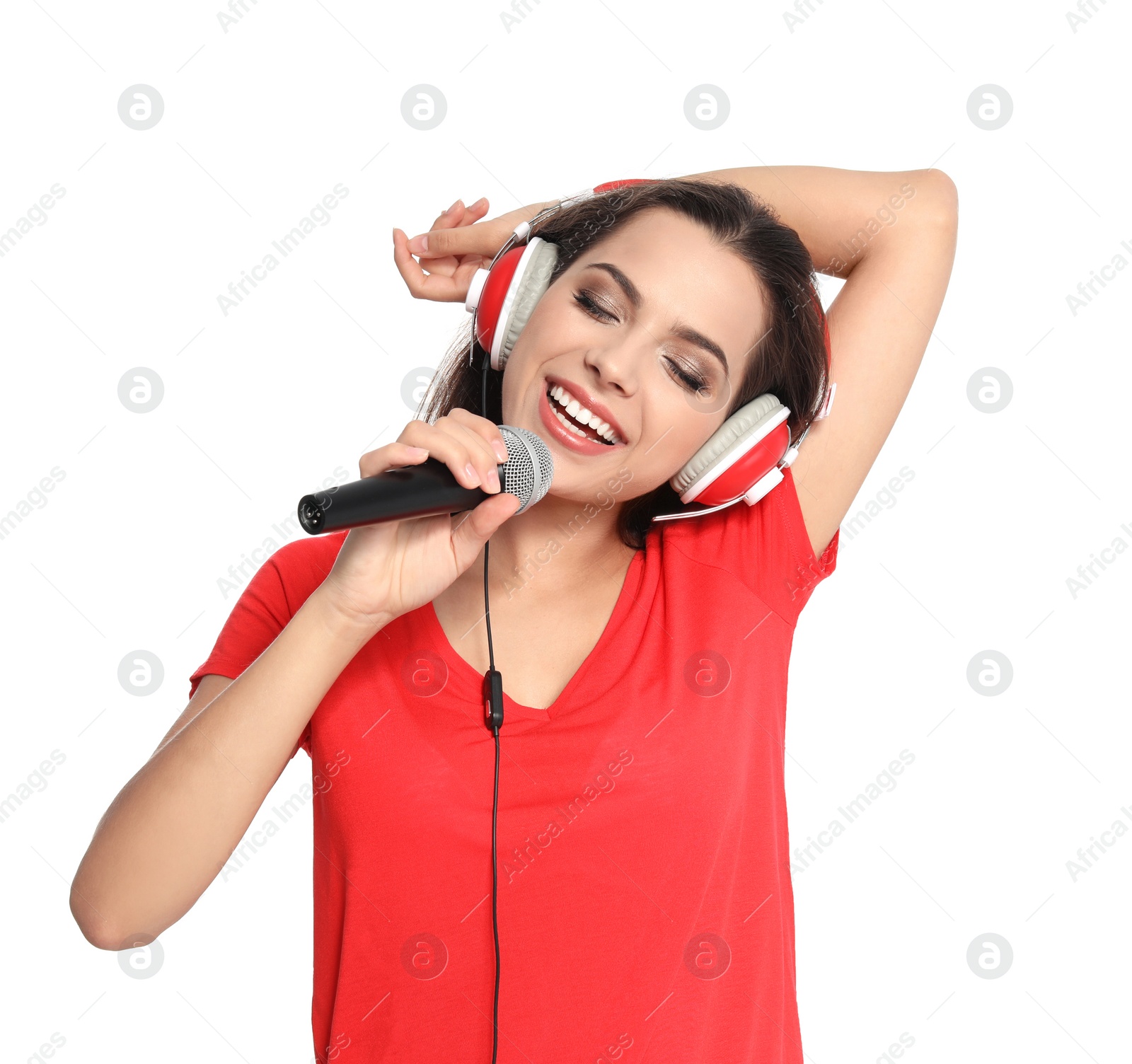 Photo of Young woman singing into microphone on white background. Christmas music
