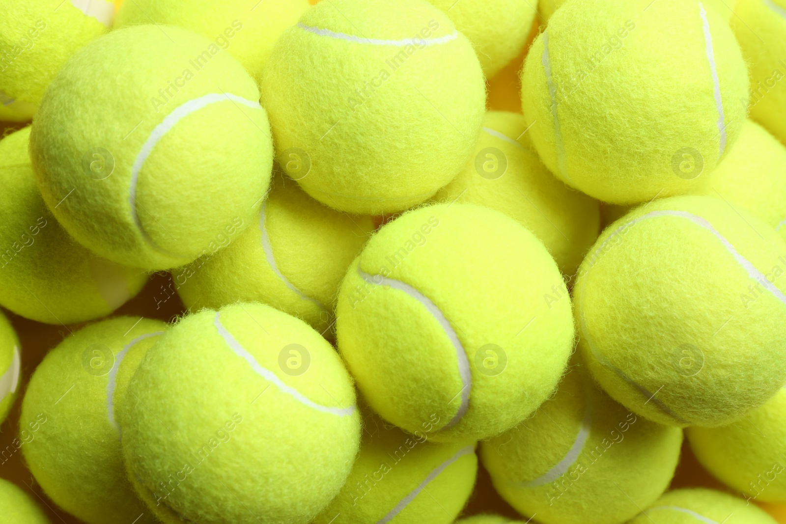 Photo of Bright tennis balls, top view. Sports equipment