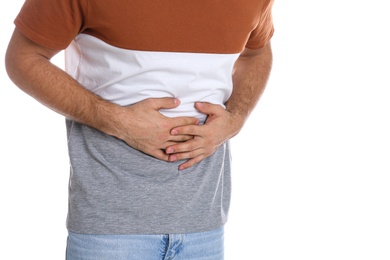 Photo of Man suffering from stomach ache on white background, closeup. Food poisoning