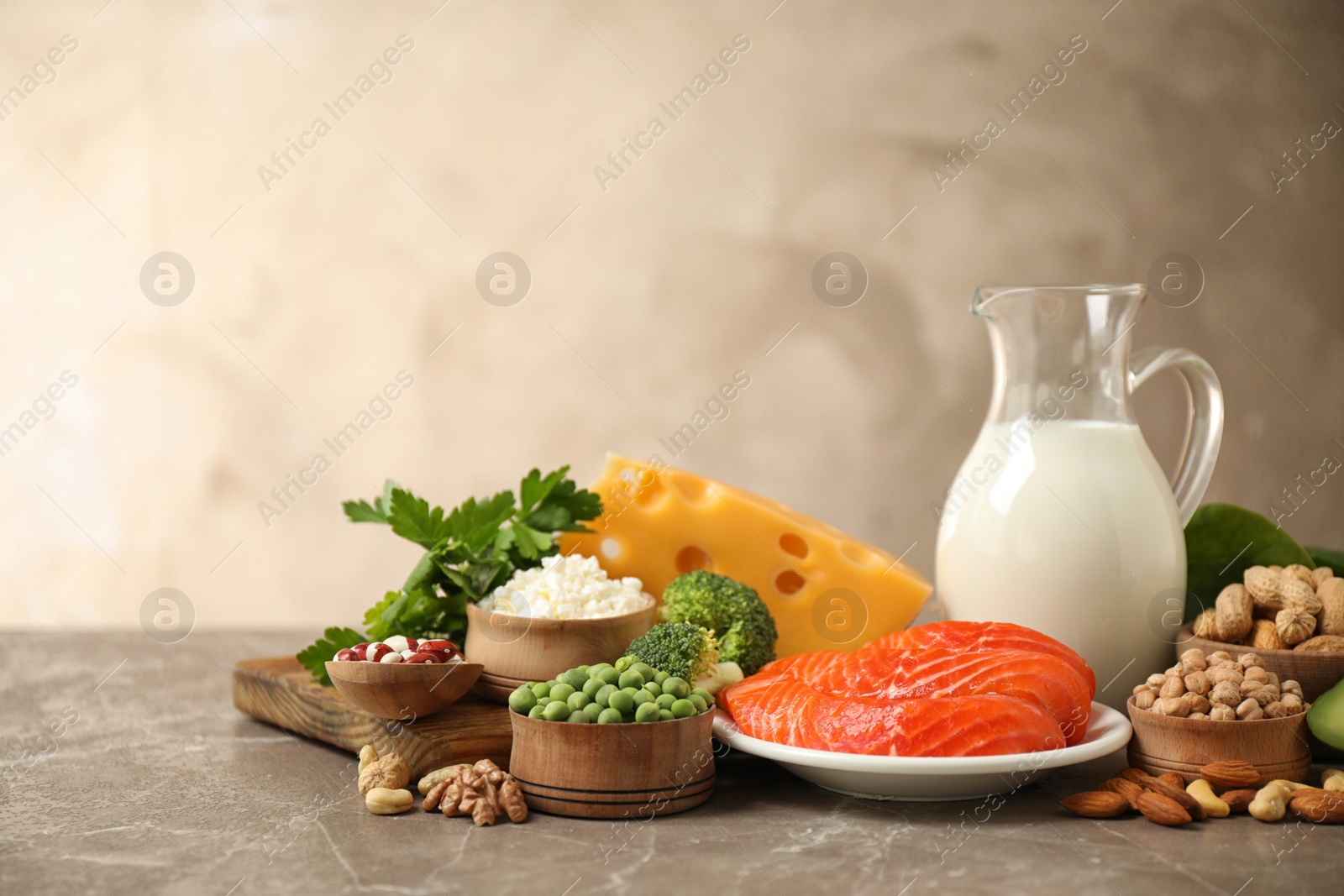 Photo of Different products rich in protein on marble table