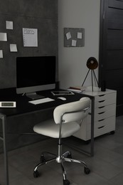 Photo of Stylish room interior with comfortable workplace near grey wall
