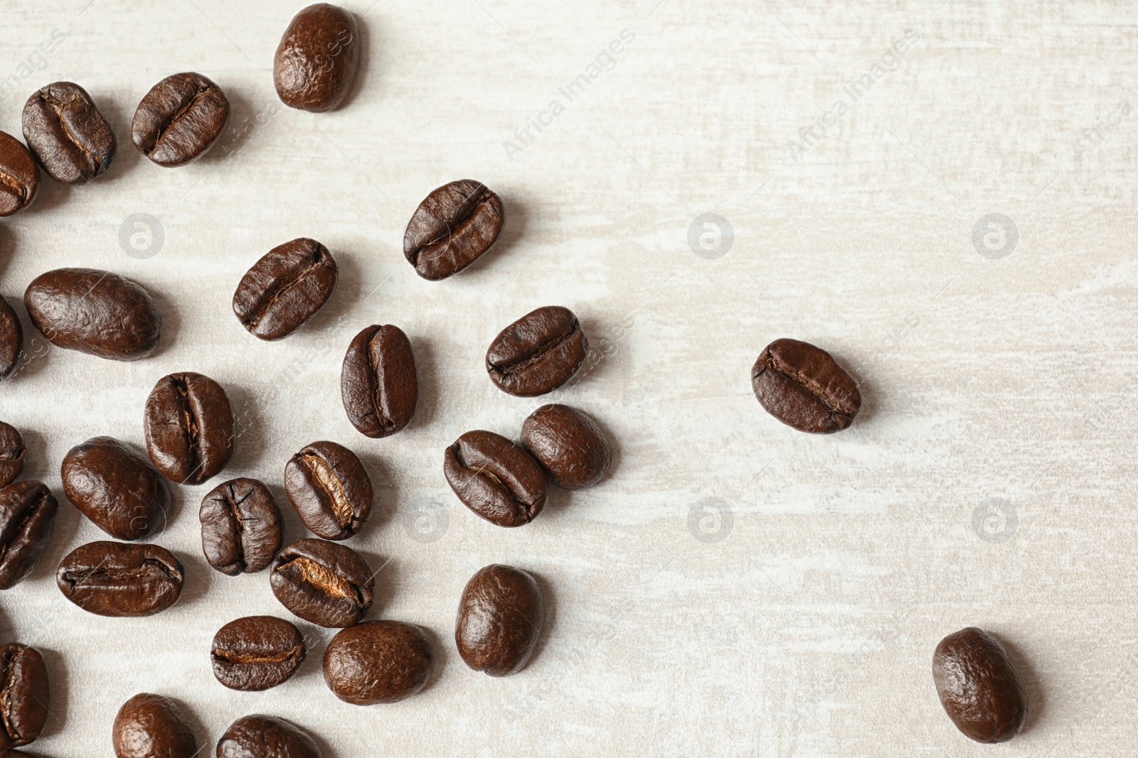 Photo of Roasted coffee beans on white background, top view