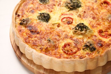 Delicious homemade vegetable quiche on white table, closeup