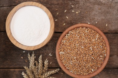 Wheat grains and flour in bowls on wooden table, flat lay