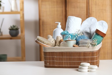 Photo of Spa gift set with different products on white table in bathroom. Space for text