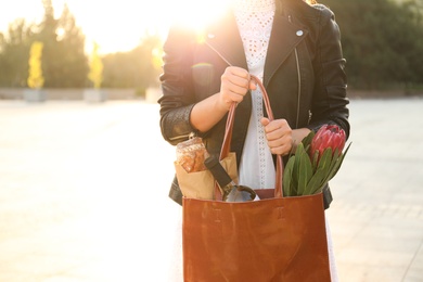 Woman with leather shopper bag on city street, closeup