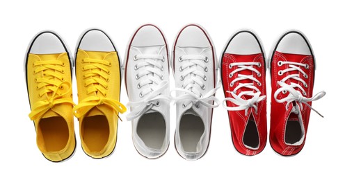 Many different sneakers isolated on white, top view