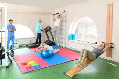Photo of Patients exercising under physiotherapist supervision in rehabilitation center