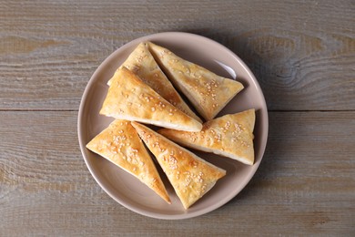 Photo of Delicious fresh puff pastries on wooden table, top view