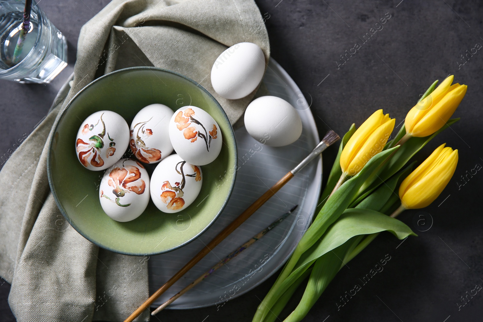 Photo of Flat lay composition with painted Easter eggs on dark table