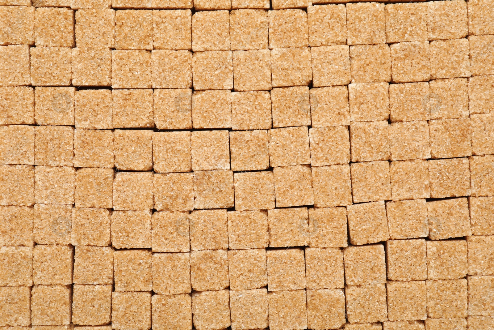 Photo of Brown sugar cubes as background, top view