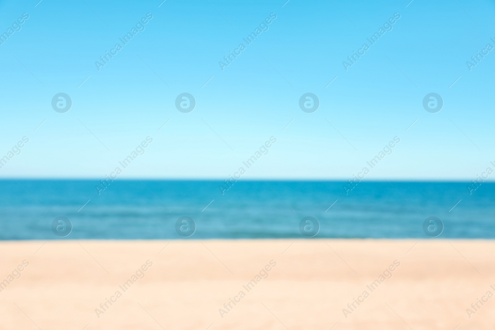 Photo of Blurred view of sandy beach near sea