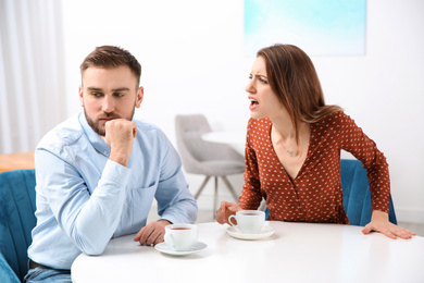 Photo of Couple having quarrel in cafe. Relationship problems