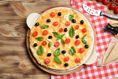 Flat lay composition with tasty homemade pizza on wooden table