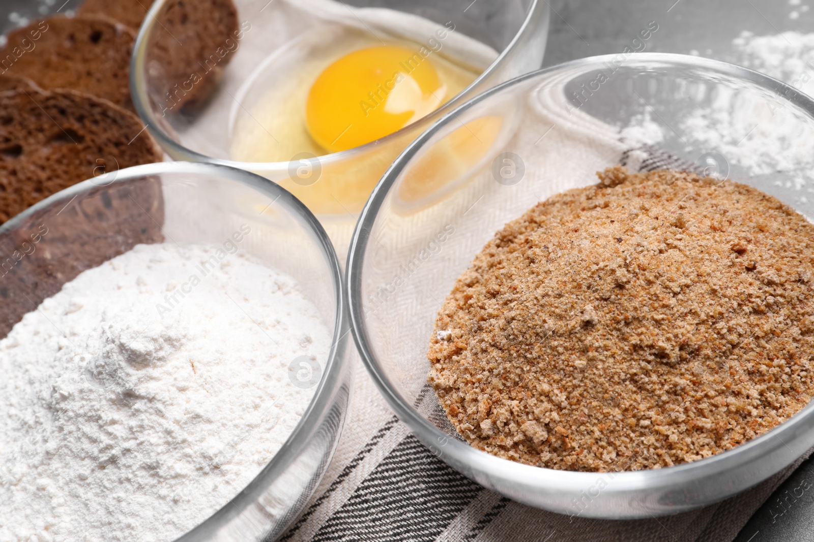 Photo of Fresh breadcrumbs, flour and egg on table, closeup