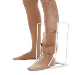 Photo of Man putting on compression garment with stocking donner against white background, closeup