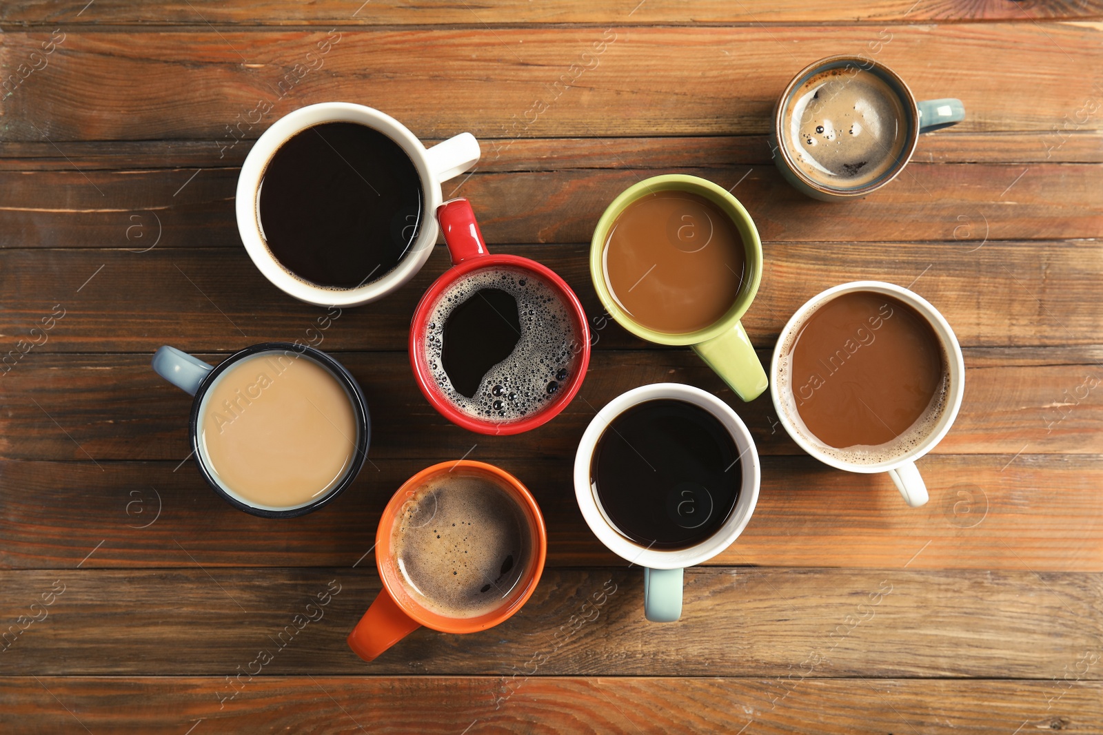 Photo of Flat lay composition with cups of coffee on wooden background. Food photography