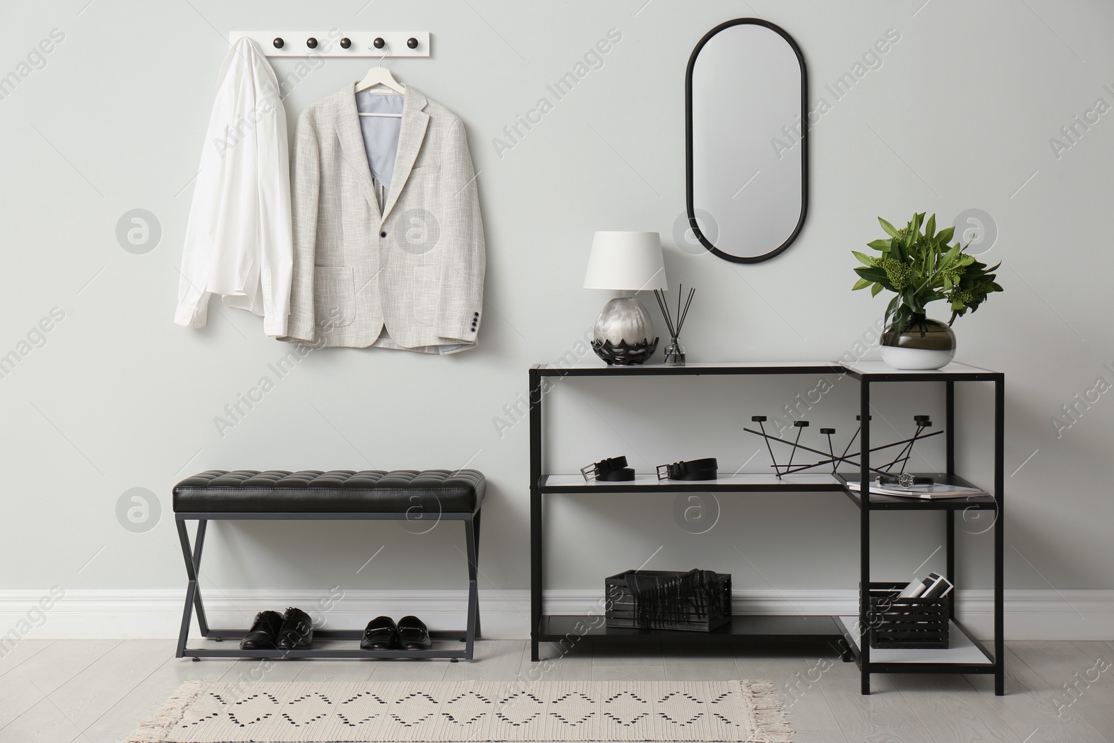 Photo of Modern hallway with stylish furniture, clothes and accessories. Interior design