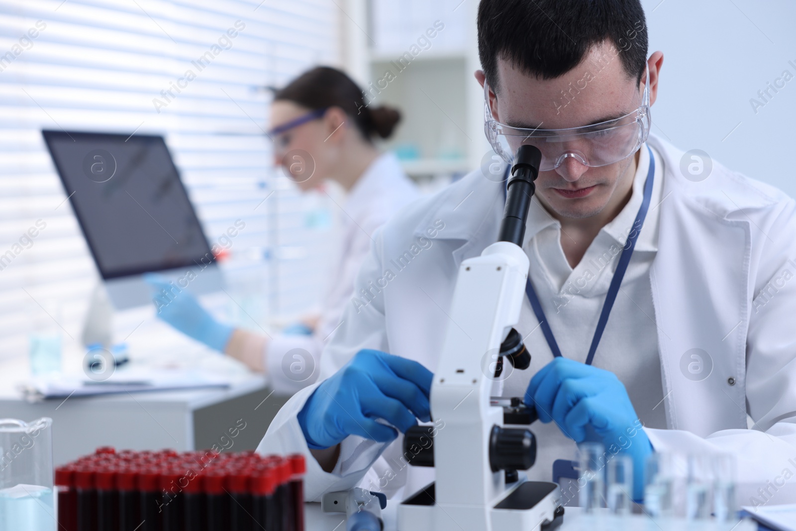 Photo of Scientist working with microscope in laboratory. Medical research