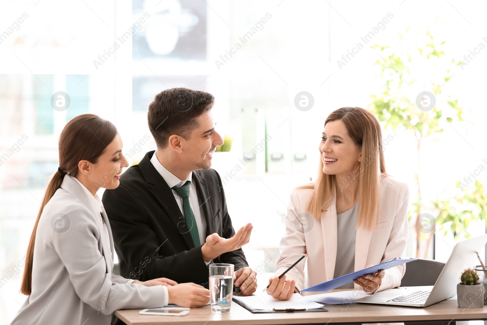 Photo of Young couple meeting with consultant in office