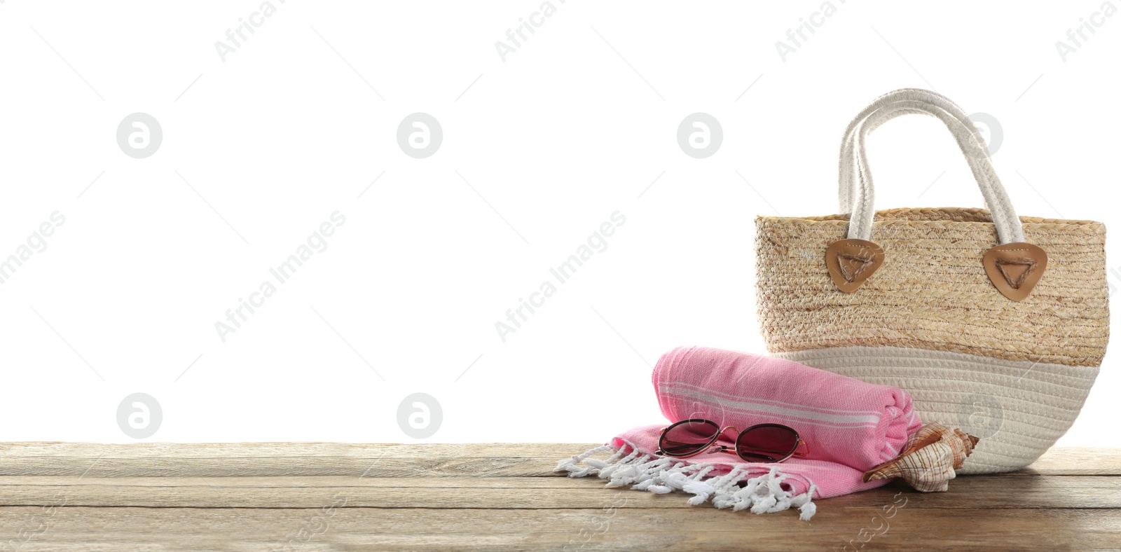 Photo of Stylish bag with beach accessories on wooden table. Space for text