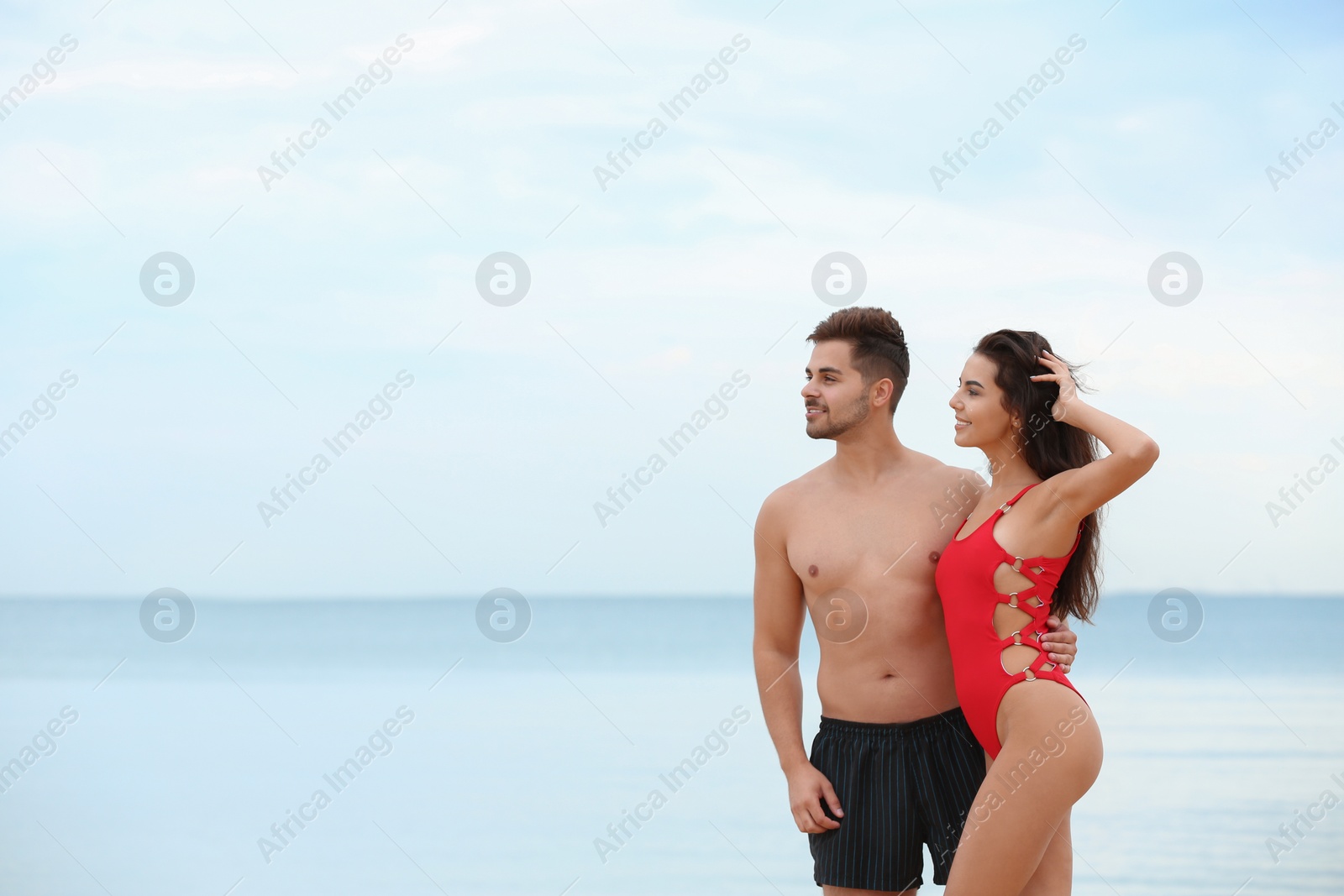 Photo of Happy young couple spending time together on beach