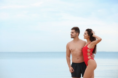 Happy young couple spending time together on beach