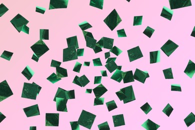 Image of Shiny green confetti falling on pink background