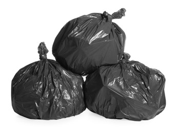 Black trash bags full of garbage on white background