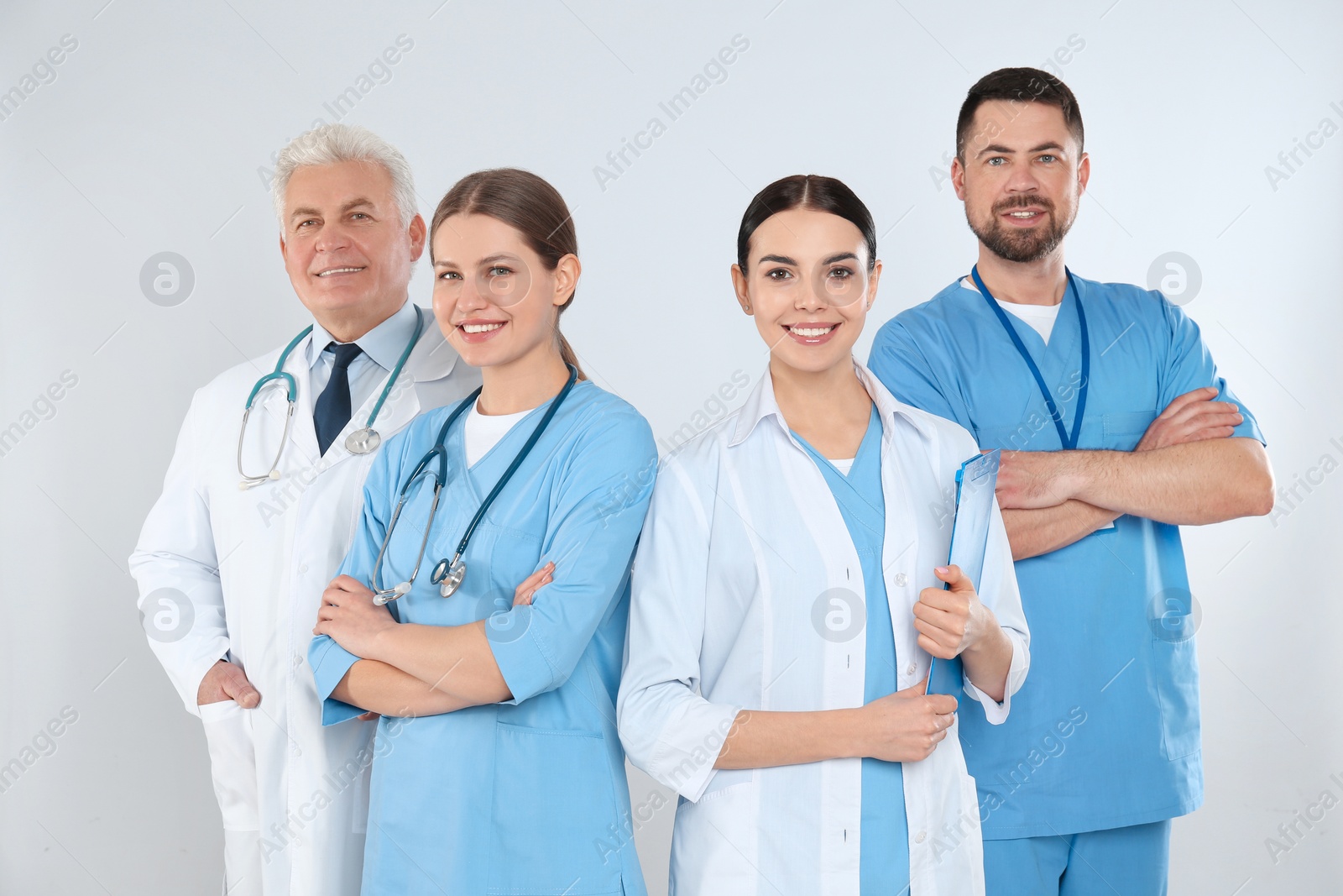 Photo of Group of doctors against light background. Medical service