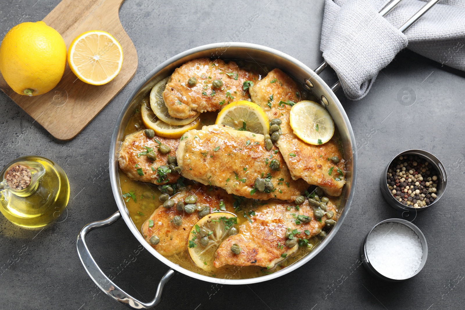 Photo of Delicious chicken piccata on grey table, flat lay