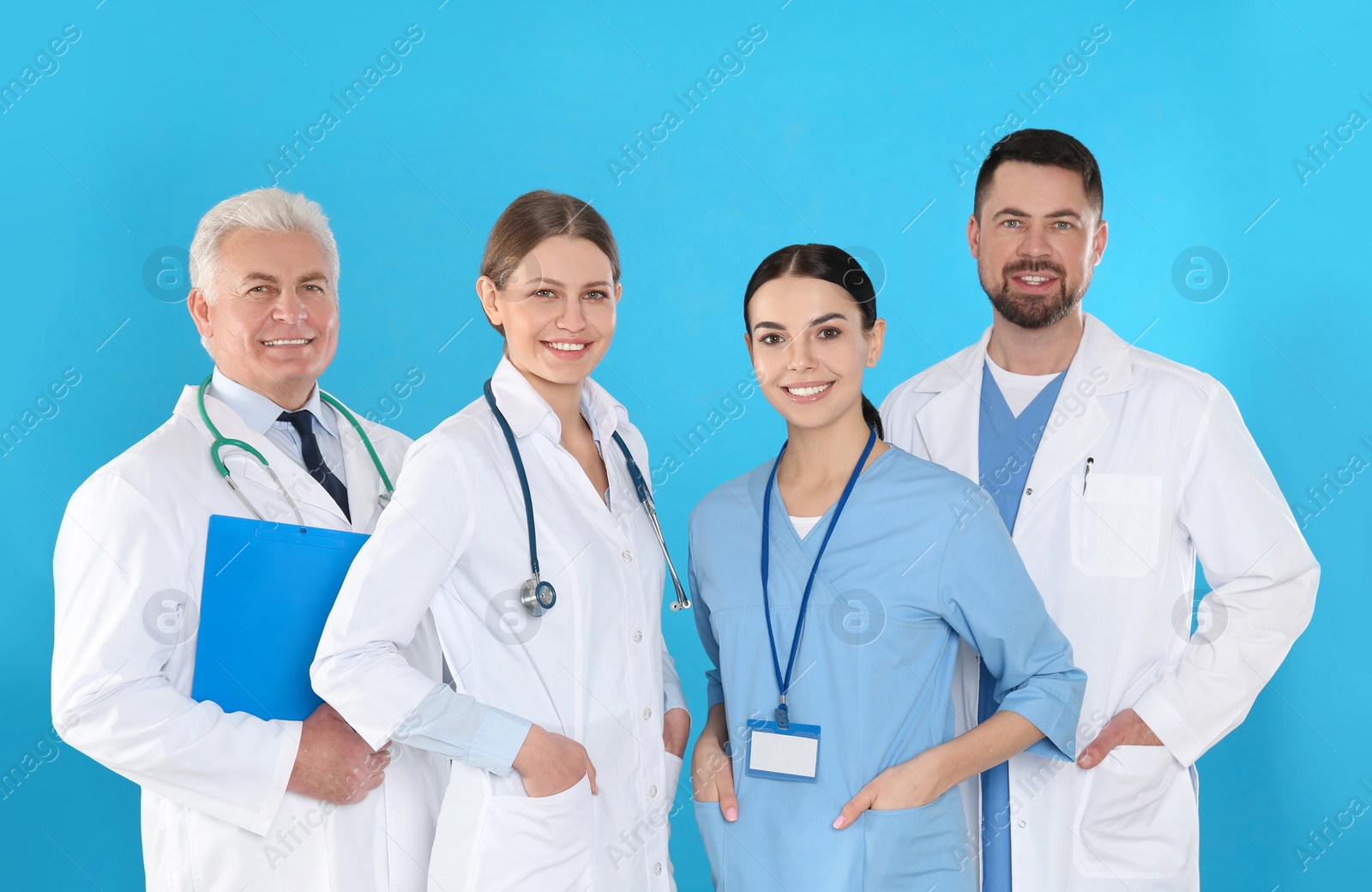 Photo of Group of doctors against blue background. Medical service