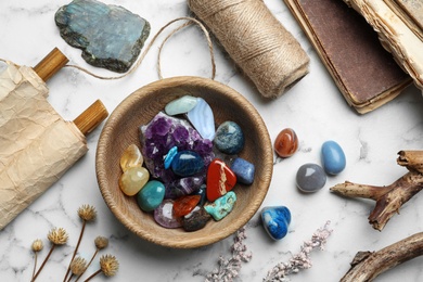 Photo of Flat lay composition with different gemstones on white marble background