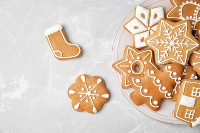 Plate with tasty homemade Christmas cookies on table, top view