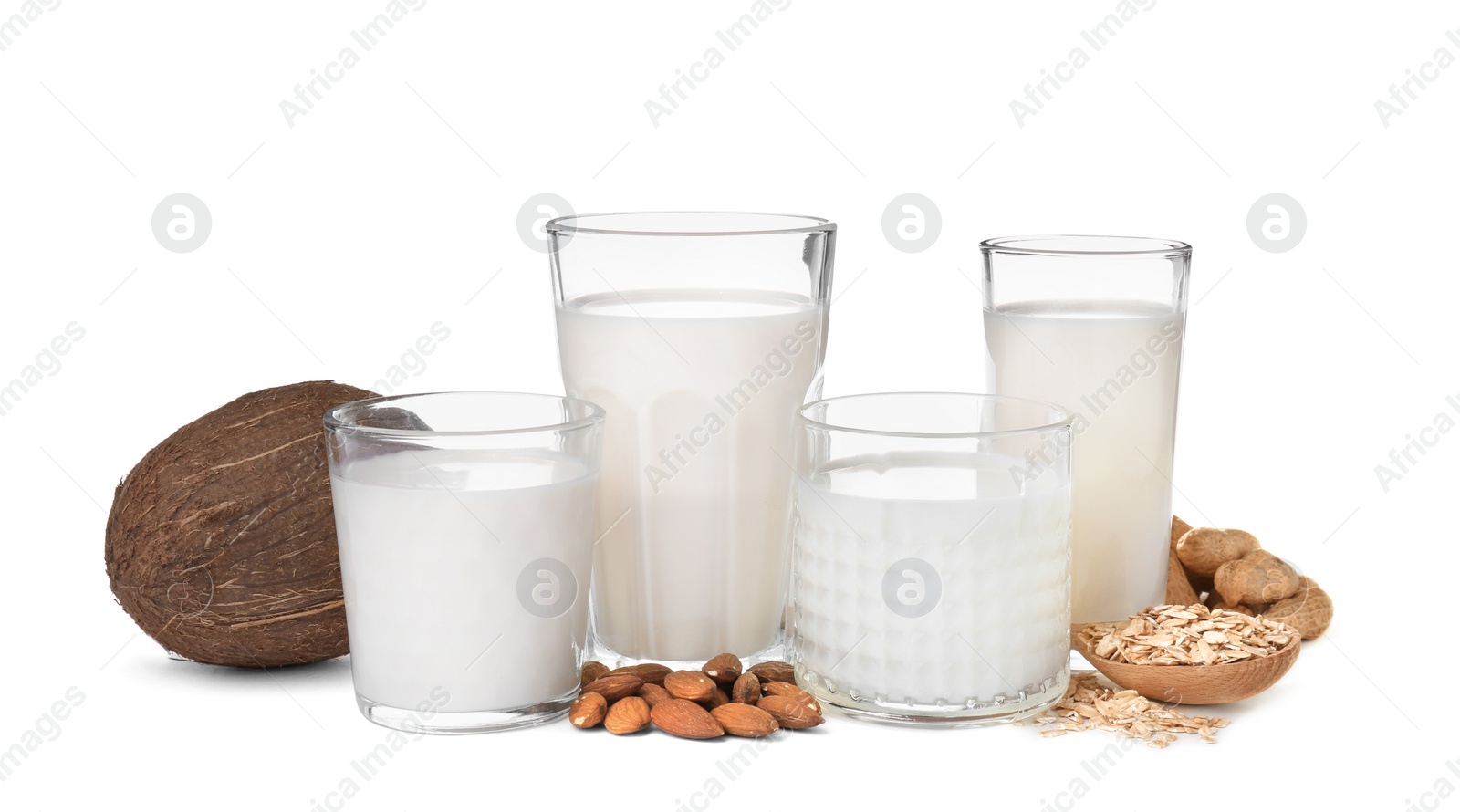Photo of Glasses with different types of milk on white background