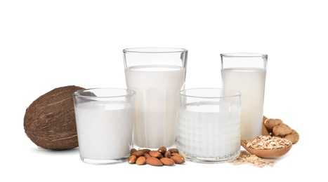 Photo of Glasses with different types of milk on white background