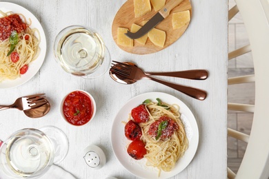 Flat lay composition with tasty pasta on white wooden table