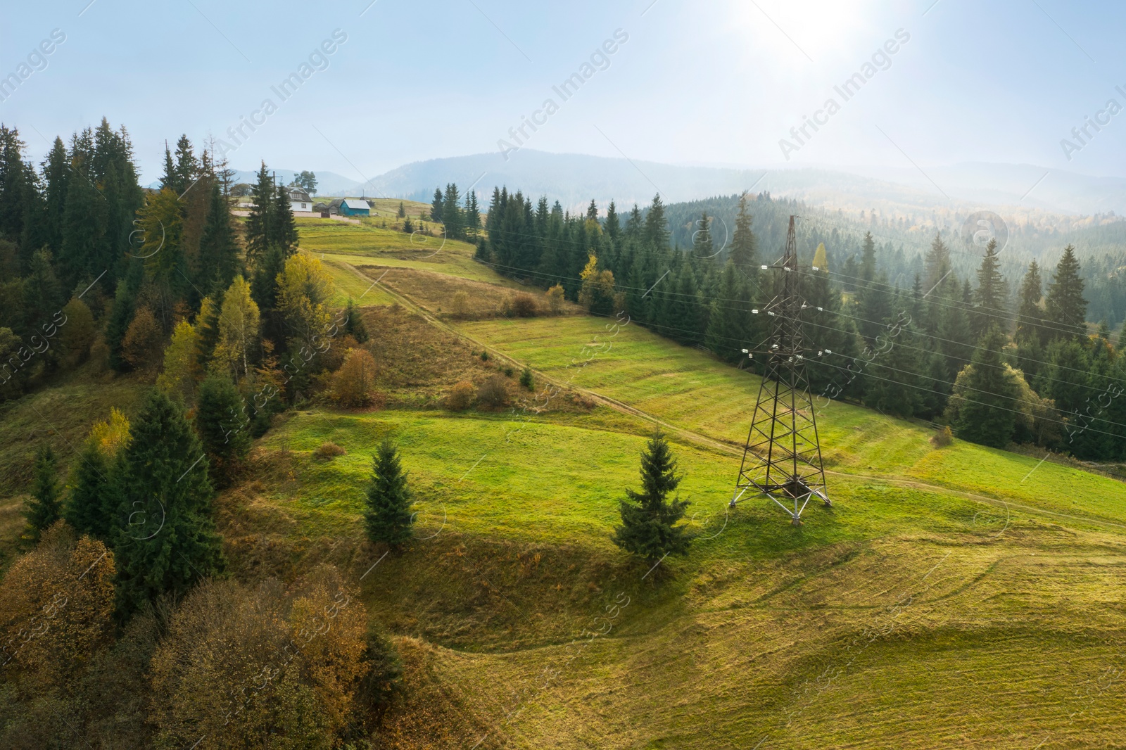 Image of Aerial view of beautiful forest and mountain village on autumn day