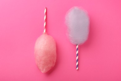 Sweet color cotton candies on pink background, flat lay