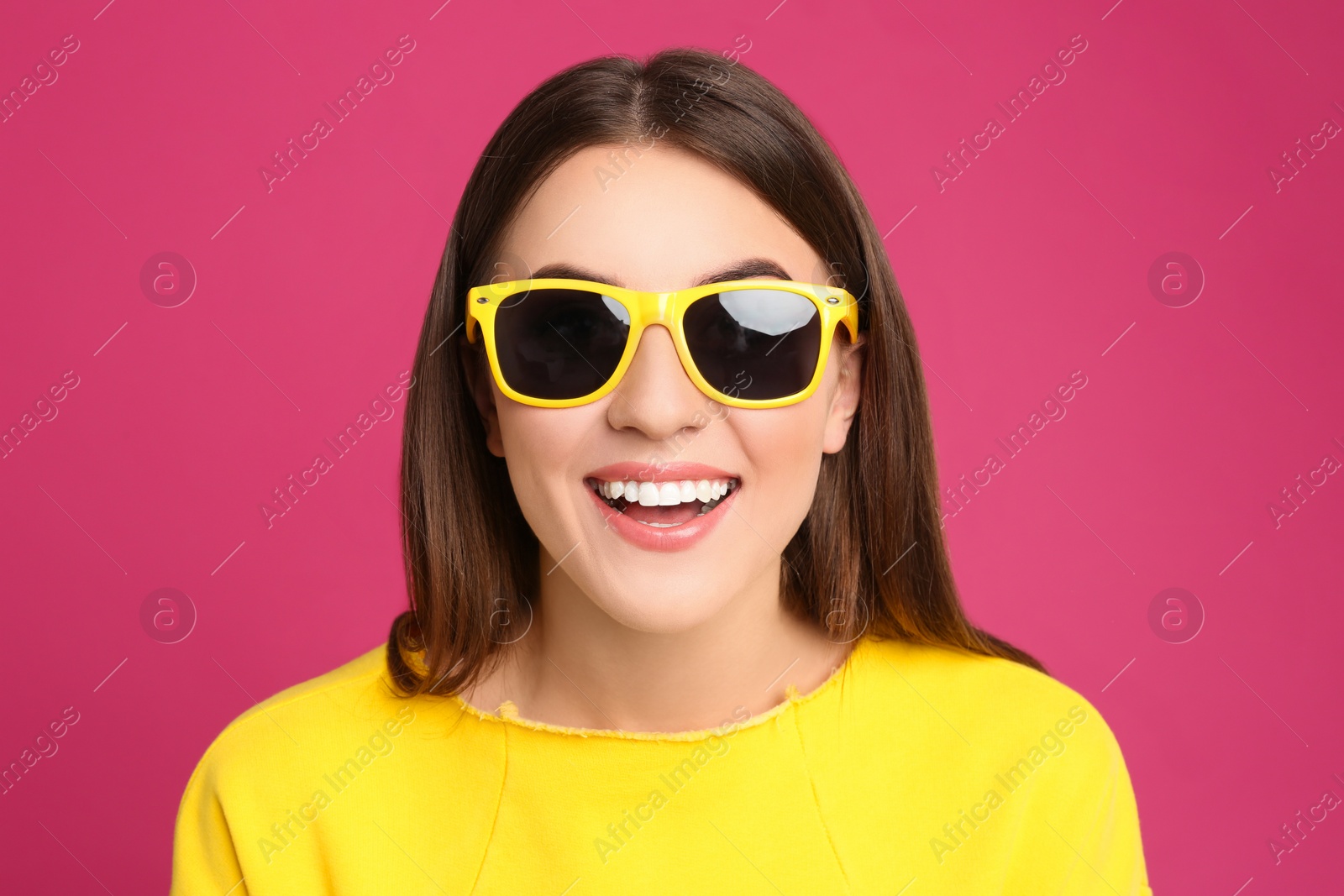 Photo of Young woman with sunglasses on pink background