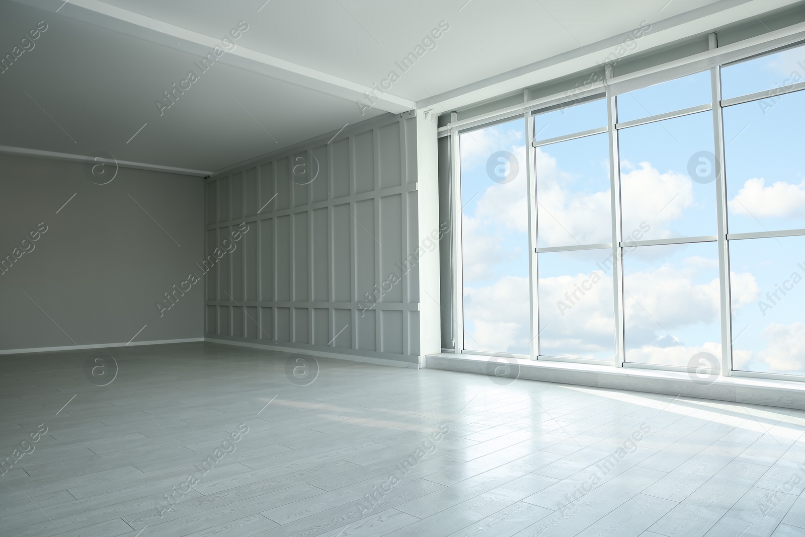 Photo of Empty room with panoramic windows and white wooden floor