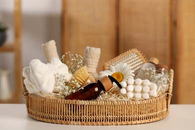 Photo of Spa gift set with different products on white table in bathroom